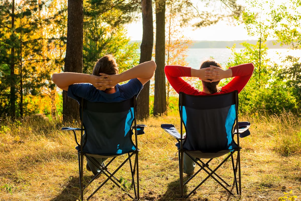 https://rvtravelcentral.com/wp-content/uploads/2021/05/camping-hacks-couple-relaxing.jpg